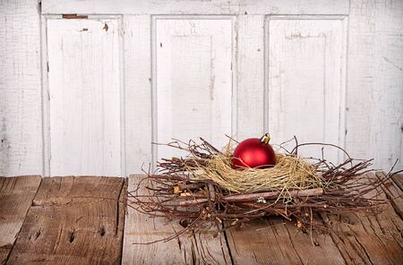 Christmas ornament in a nest  on wooden backgroundの写真素材