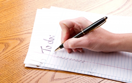Person filling out a to do listの写真素材