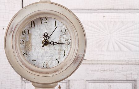 Antique clock on aged background