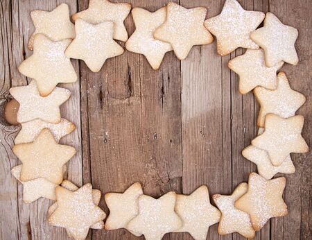 Star Christmas cookies framed on wooden backgroundの写真素材