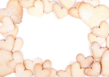 Heart shaped sugar cookies stacked framing a white backgroundの写真素材