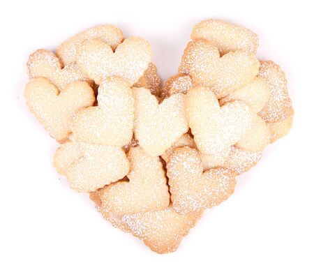 Heart shaped sugar cookies stacked in the shape of a heart on white backgroundの写真素材