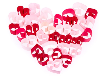 Paper shaped like a heart in shades of pink and red on a white backgroundの写真素材