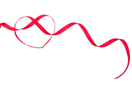 red ribbon in the shape of a heart isolated on whiteの写真素材