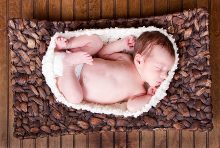 Newborn infant baby laying in a basketの写真素材