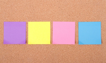 assorted blank sticky notes on a bulletin board