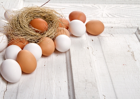 Brown eggs in a nest on a cracked antique wooden panelの写真素材
