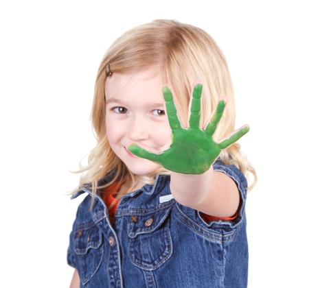 A child with green paint on her hand isolated on a white backgroundの写真素材