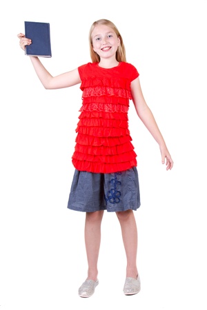 teen holding a book above head, isolated on a white backgroundの写真素材