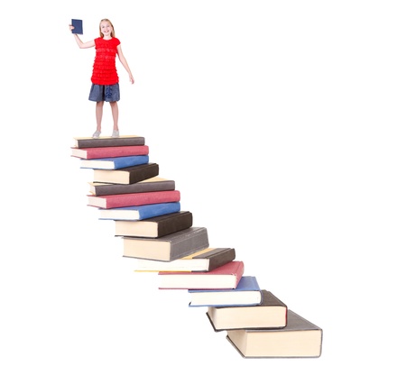 Teen on top of book stair case holding book isolated white backgroundの写真素材