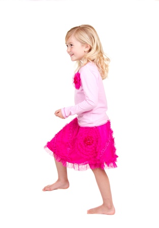 Young child in the action of stepping up isolated on whiteの写真素材