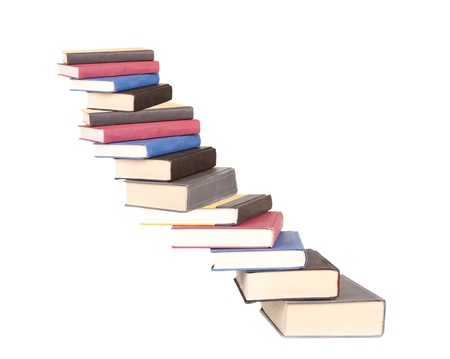 a stair case of books isolated on a white backgroundの写真素材