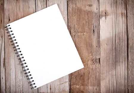 Blank sketch book or notebook on wooden plank for backgroundの写真素材