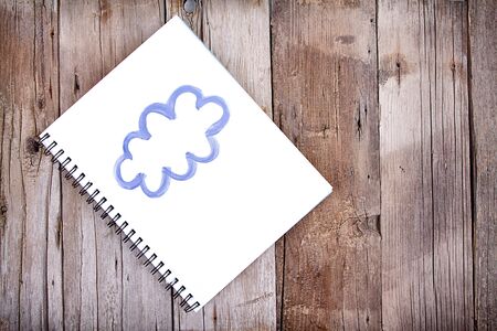Painting of cloud on notebook or sketch book with paintbrush, close-upの写真素材