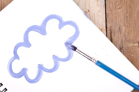 Painting of cloud on notebook or sketch book with paintbrush, close-upの写真素材