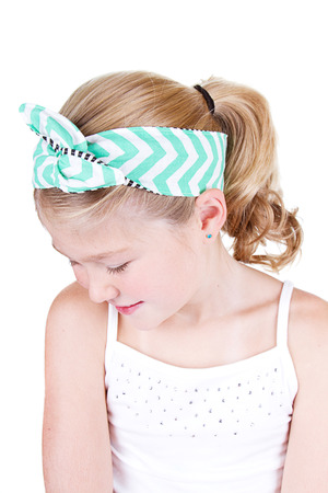 Fashionable young girl wearing vintage fabric headband, isolated on whiteの写真素材