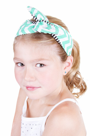 Fashionable young girl wearing vintage fabric headband, isolated on whiteの写真素材