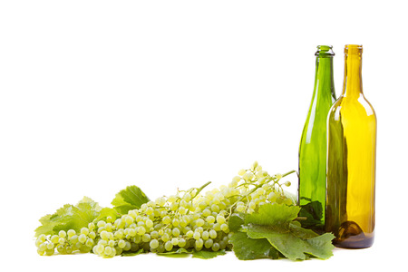 grapes on vine with leaves and empty wine bottles on white backgroundの写真素材