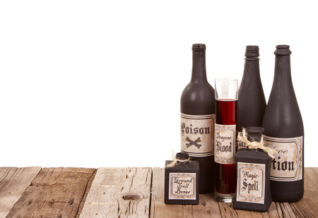 Potion bottles on wooden crates, isolated on a white backgroundの写真素材