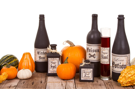 Potion bottles with pumpkins on  wooden crates, isolated on white.の写真素材