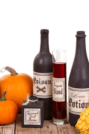 Potion bottles with pumpkins on  wooden crates, isolated on white.の写真素材