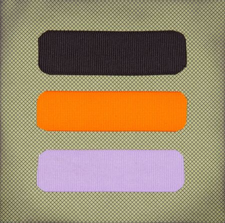 Halloween colored ribbon tags on a scrapbook paper backgroundの写真素材