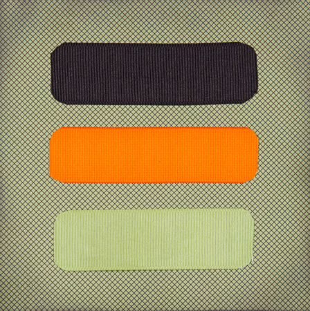 Halloween colored ribbon tags on a scrapbook paper backgroundの写真素材