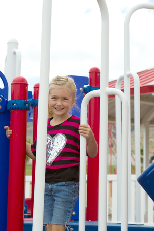 Child climbing on playground equiptment outsideの写真素材