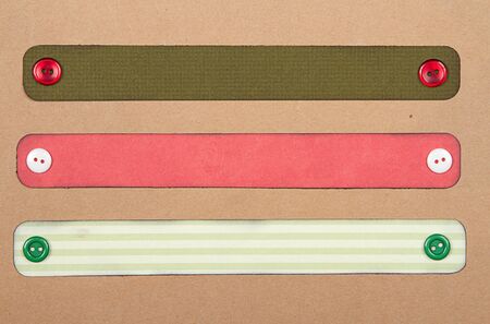 Christmas paper tags with buttons on scrabook paper backgroundの写真素材