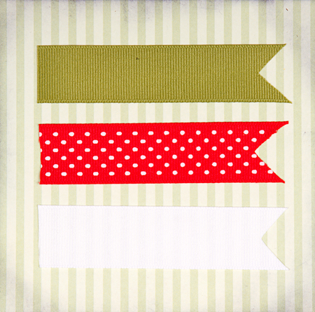 Christmas ribbon tags on a scrabook paper backgroundの写真素材