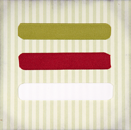 Christmas ribbon tags on a scrabook paper backgroundの写真素材