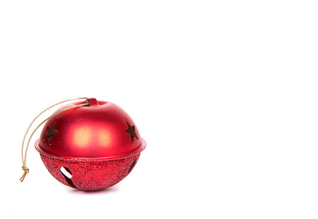 A red Christmas Jingle bell on a white backgroundの写真素材