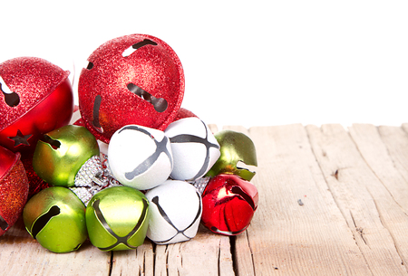 Christmas jingle bells on a rustic wooden plankの写真素材