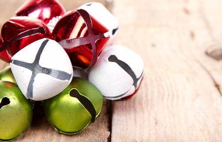 Christmas jingle bells on a rustic wooden plankの写真素材