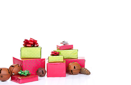 Christmas presents on isolated white background with rustic jingle bells.の写真素材