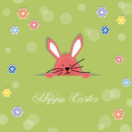 Easter bunny poking its head out of cut in paper, decorated with flowersの写真素材
