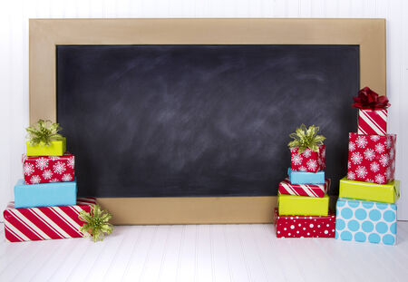 Christmas presents grouped around a chalkboardの写真素材