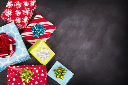 Christmas presents grouped around a chalkboardの写真素材