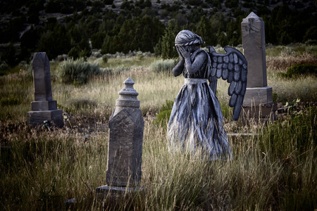 Girl wearing a home made life like angel costume in an old grave yardの写真素材