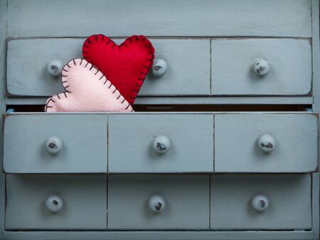 Two hearts inside a drawer in a dresser or chestの写真素材