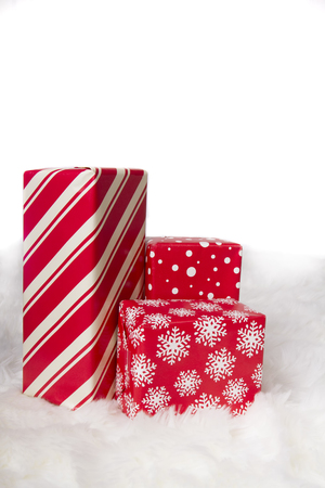 Red and White Christmas presents on a faux fur background. の写真素材