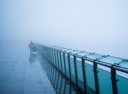 Woman walking on a bridgeの写真素材