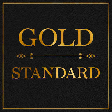 A gold leaf and black leather effect GOLD STANDARD phrase typographical graphic illustration with black leather backgroundの写真素材