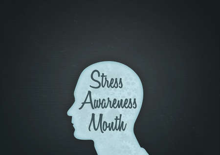 An illustration of a unisex silhouette of a human head containing Stress Awareness Month with dark background and copy space and subtle texturesの写真素材