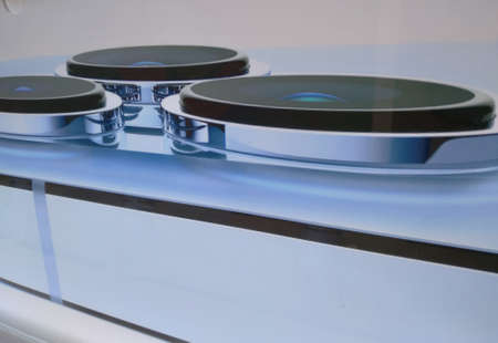 Close-up shot of a smartphone camera placed on a clear glass floor, modern communication technology in the digital era.の写真素材