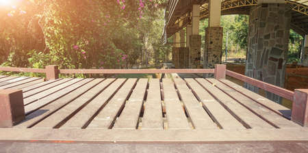 The steel walkway in the park forest provides a beautiful natural morning glow for a background or...