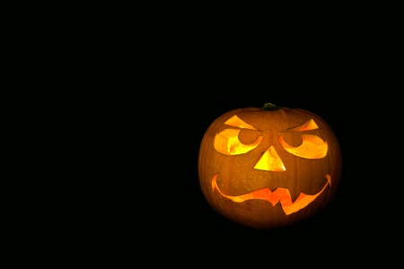 ghastly halloween pumpkin on black backgroundの写真素材