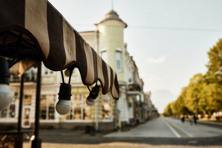 Light bulbs on terrace of cafe close-up on background of city street. Vladikavkaz, North Ossetia, Russia.の写真素材