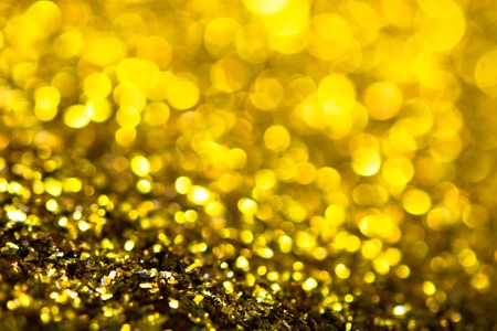 Golden glitter texture. Festive sparkling sequins background closeup. Luxury shiny walpaper for the day of St. Valentine, New Year, Unniversary celebration and Christmas Holidays.の写真素材