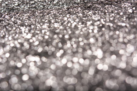 Silver glitter texture. Festive sparkling sequins background closeup. Luxury shiny walpaper for the day of St. Valentine, New Year, Unniversary celebration and Christmas Holidays.の写真素材
